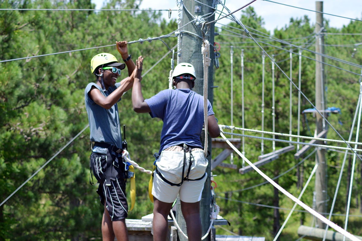 High fives on the ropes course